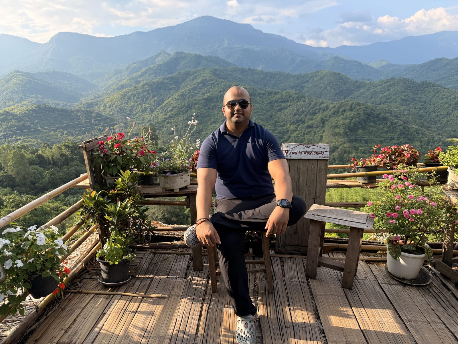 Saurabh on a mountain deck surrounded by flowers
